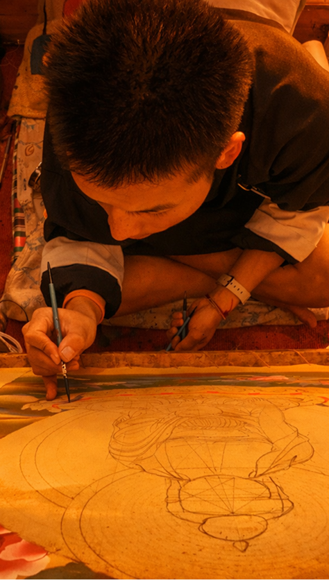 Bhutanese artist painting a sacred Thangka scroll